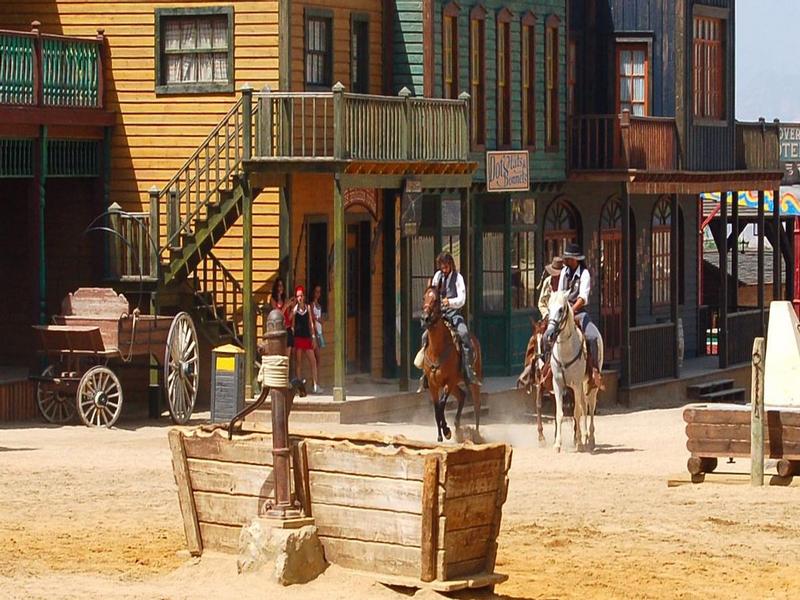 Cowboys riding through a Wild West film set in the Tabernas desert, Filabres-Tabernas, Almería — visit with Andaluciatours.