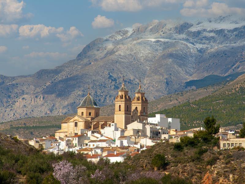 A white town below the snow-dusted Sierra de María in Los Vélez, Almería — discover the highlands with Andaluciatours.