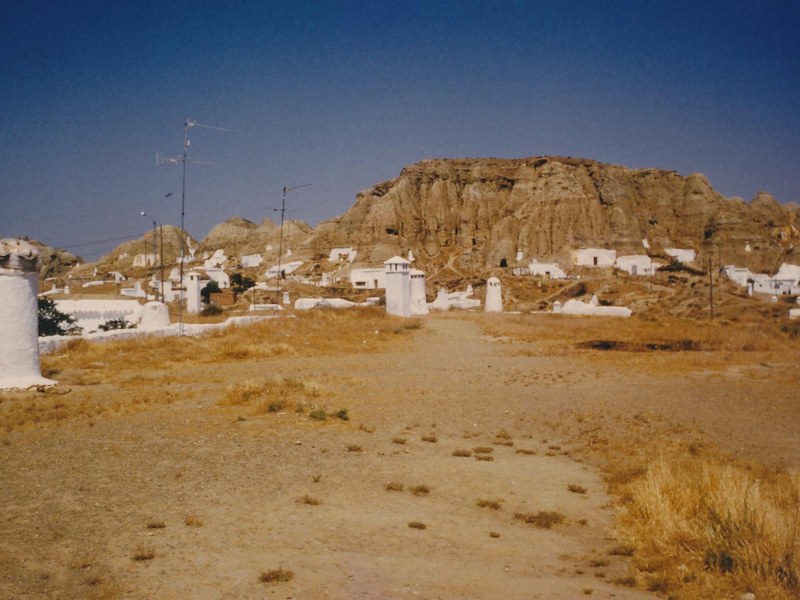 Whitewashed cave houses with chimneys in the troglodyte district of Guadix, Granada, Spain